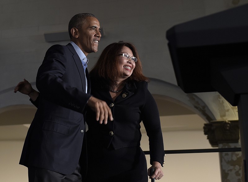 
              President Barack Obama, left, is welcomed on stage by Rep. Tammy Duckworth, D-Ill., right, to speak at the Stony Island Arts Bank during a fundraiser for Duckworth's Senate campaign in Chicago, Sunday, Oct. 9, 2016. Obama spent the weekend in Chicago where he voted, played golf and attended a fundraiser. (AP Photo/Susan Walsh)
            