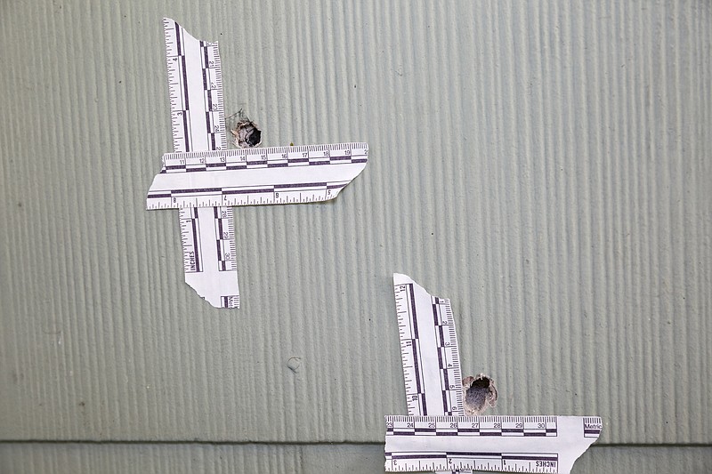 Bullet holes are visible in the siding of the home where LaDarious Bush, 17, was shot and killed on Seventh Avenue in a wave of gang violence earlier this year.