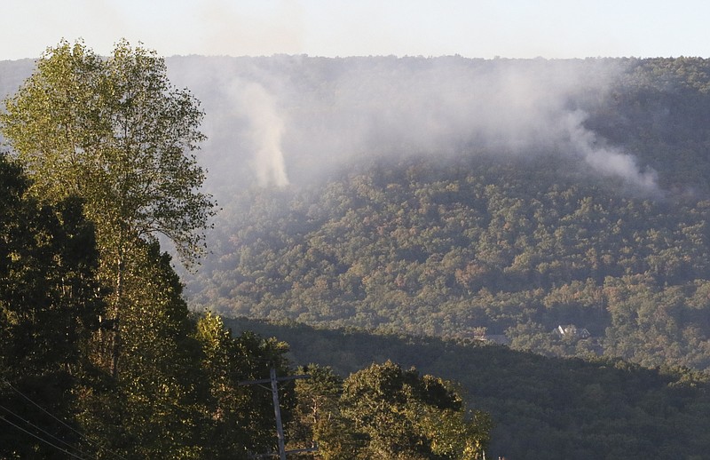A brush fire off in the distance near Roberts Mill Road that grew to 20 acres Saturday had fire crews responding again after resuming on Sunday, Oct. 9, 2016.