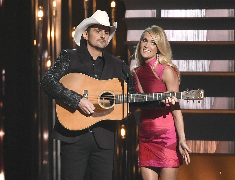 
              FILE - In this Nov. 4, 2015 file photo, hosts Brad Paisley, left, and Carrie Underwood speak at the 49th annual CMA Awards in Nashville, Tenn. Paisley and Underwood, along with Dierks Bentley, Eric Church, Maren Morris and Keith Urban will perform at the 50th annual Country Music Association Awards show on Nov. 2. (Photo by Chris Pizzello/Invision/AP, File)
            