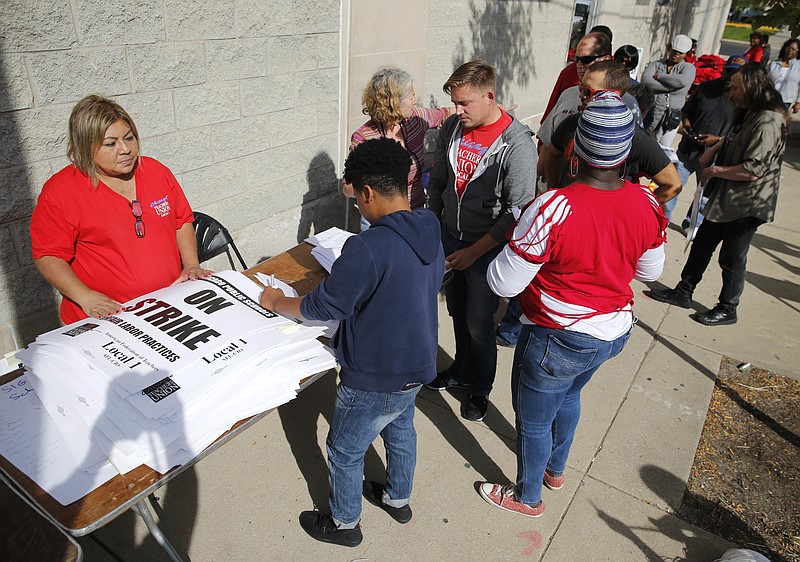 
              Chicago Teachers Union members pick up strike material outside union's strike headquarters Monday, Oct. 10, 2016, in Chicago. Negotiators for the union and Chicago Public Schools continue to meet in an effort to reach a contract and avert a threatened teachers' strike. (AP Photo/Charles Rex Arbogast)
            