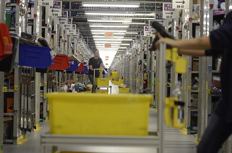 Pickers, individuals who find and fulfill orders from rows of shelves, dart around the floor on the Enterprise South industrial park distribution center in Chattanooga.