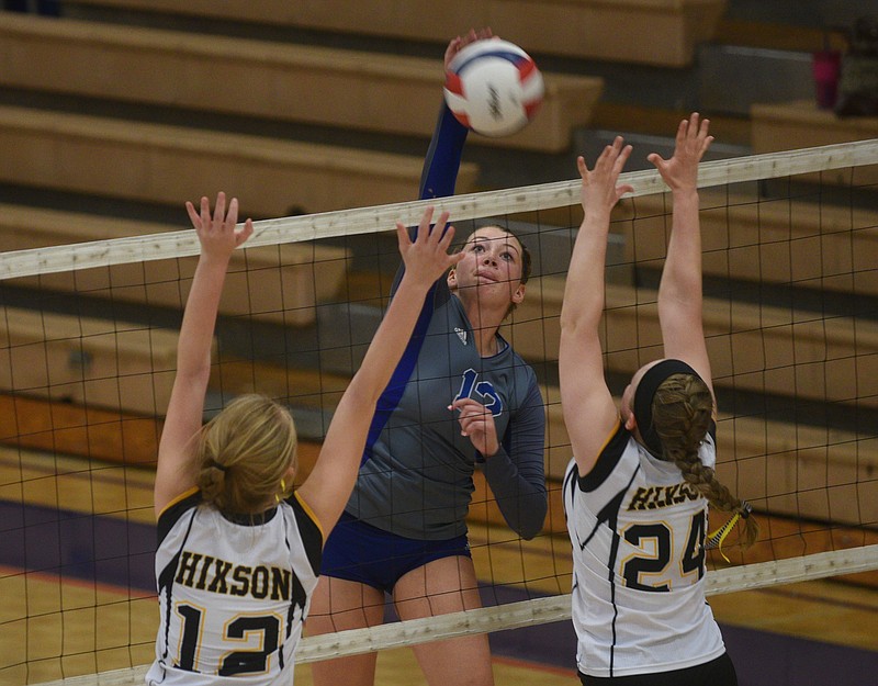 Red Bank's Hannah Wood spikes against Hixson's Courtney Jones, left, and Sam Dove during their Region 3-AA title match Tuesday at Red Bank High School. The host Lady Lions won 3-0 in a rematch of the district final.