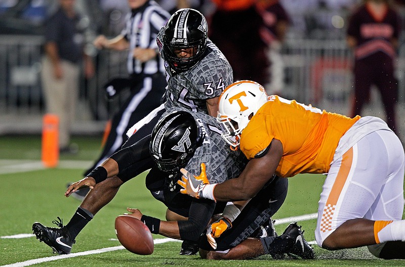 Tennessee defensive lineman Shy Tuttle dives for the loose ball on his way to a fumble recovery during the Vols' victory against Virginia Tech last month at Bristol Motor Speedway.