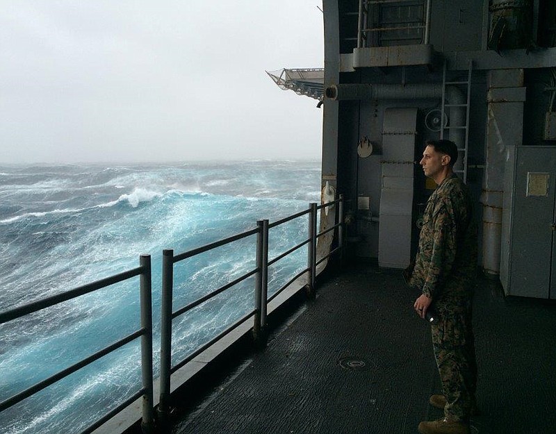 
              In this Sunday, Oct. 9, 2016 photo, Marine Gunnery Sgt. Jeremiah Benjamin, 34, of San Diego, watches the Atlantic churn aboard the USS Iwo Jima. Benjamin is among a group of Marines and sailors bound for Haiti to help out with relief efforts following Hurricane Matthew's destruction. (AP Photo/Ben Finley)
            