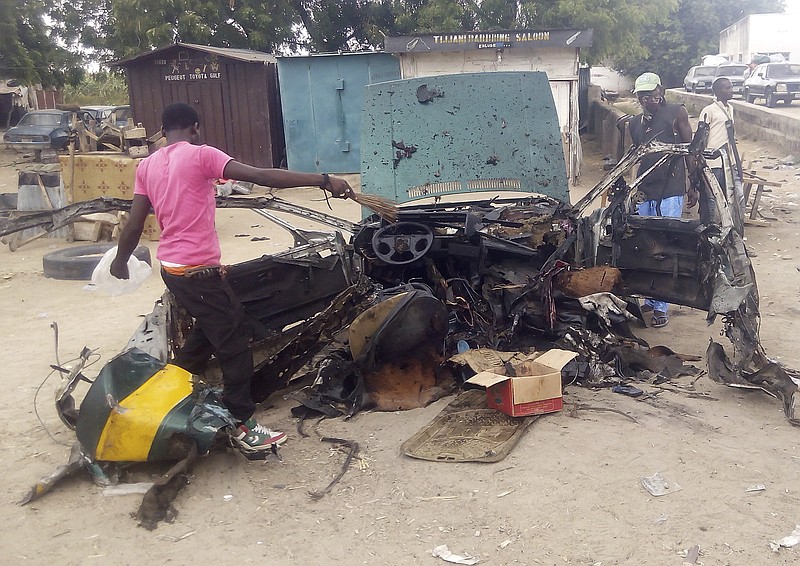 
              People gather at the scene of a car bomb explosion in Maiduguri, Nigeria, Wednesday, Oct. 12, 2016. An explosion targeted a taxi filled with passengers in northeast Nigeria on Wednesday, killing at least seven in the deadliest bombing to hit the area’s largest city in several months, officials and witnesses said. (AP Photo/Ismail Alfa Abdulrahim)
            