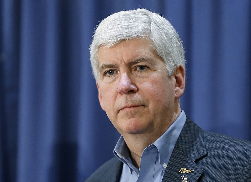 
              FILE - In this Feb. 26, 2016, file photo, Michigan Gov. Rick Snyder listens to a question after attending a Flint Water Interagency Coordinating Committee meeting in Flint, Mich. A Flint resident filed a complaint Tuesday, Oct. 11, 2016, asking for a grand jury investigation of Snyder’s decision to use at least $2 million in state funds for his legal representation related to criminal probes of the city’s water crisis. The complaint alleges that the governor broke the law by violating conflict-of-interest prohibitions and “unilaterally” spending taxpayer money for personal benefit without the authority to do so. (AP Photo/Paul Sancya, File)
            