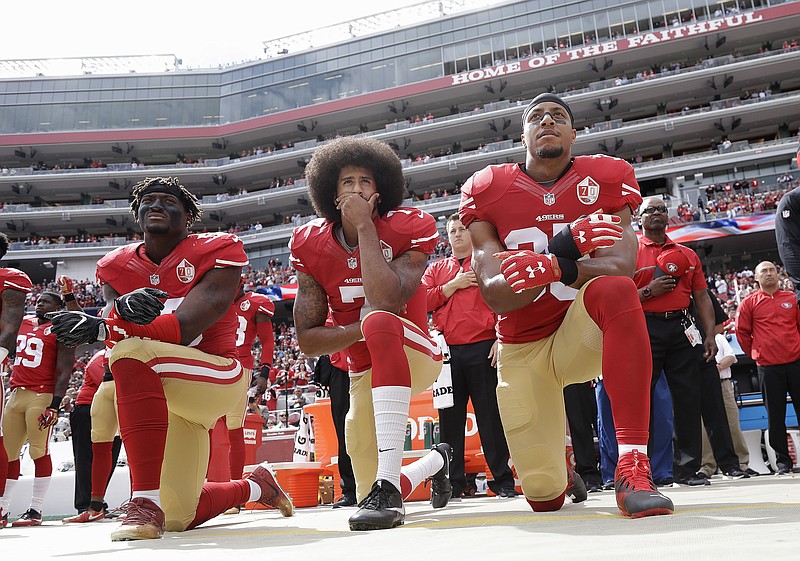 
              FILE - In this Oct. 2, 2016 file photo, from left, San Francisco 49ers outside linebacker Eli Harold, quarterback Colin Kaepernick and safety Eric Reid kneel during the national anthem before an NFL football game against the Dallas Cowboys in Santa Clara, Calif. A new poll shows that most white Americans disapprove of athletes protesting during the playing of “The Star-Spangled Banner.”  (AP Photo/Marcio Jose Sanchez, File)
            