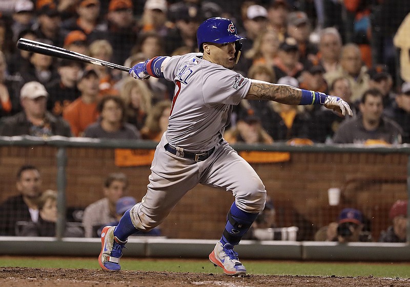 Chicago Cubs' Javier Baez hits a run-scoring single against the San Francisco Giants during the ninth inning of Game 4 of baseball's National League Division Series in San Francisco, Tuesday, Oct. 11, 2016.