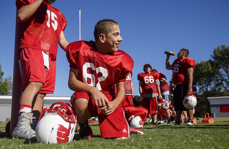 Whitwell football player Brendyn Gartyn takes a knee for a water break during football practice at Whitwell High School on Wednesday, Sept. 28, 2016, in Whitwell, Tenn.