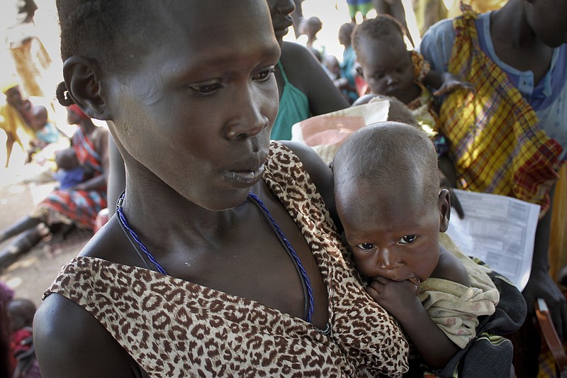 
              In this photo taken on Friday, Sept. 16, 2016, Elizabeth Athiel holds her 8-month-old malnourished daughter Anger, at a UNICEF clinic in Aweil, South Sudan. Between 4 and 5 million people are at risk of death if they do not receive food assistance, according to the World Food Program, and even as the government has repeatedly promised full humanitarian access to this and other areas, South Sudanese officials have restricted aid amid their hostility at the international community. (AP Photo/Justin Lynch)
            