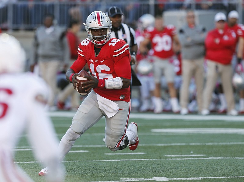 In this Oct. 8, 2016, file photo, Ohio State quarterback J.T. Barrett runs the ball against Indiana during NCAA college football game in Columbus, Ohio. Barrett goes into Saturday's game against Wisconsin looking to strengthen his Heisman Trophy candidacy after last week's poor passing performance against Indiana.  (AP Photo/Jay LaPrete, File)