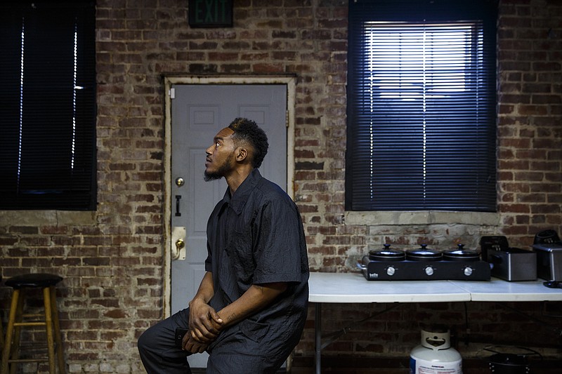 Deisman Harrison sits in the back room of the Dodson Avenue barber shop where he works Wednesday, Sept. 28, 2016, in Chattanooga, Tenn. Harrison's friend, Johny Montgomery, was murdered in Walker County, Ga., last year.