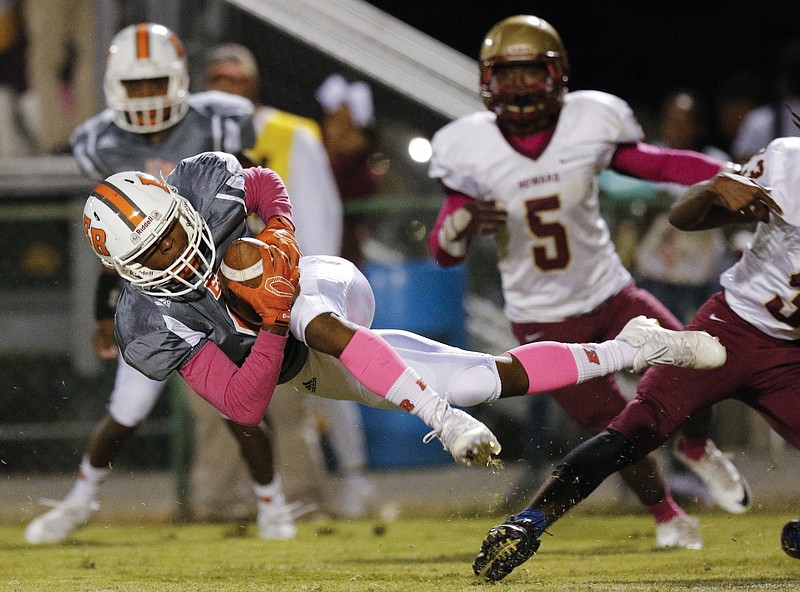 East Ridge's Traneil Moore dives with the ball ahead of Howard defender Calvin Johnson (5) during their prep football game at East Ridge High School on Friday, Oct. 14, 2016, in East Ridge, Tenn.