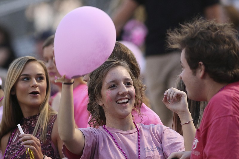 Staff Photo by Dan Henry / The Chattanooga Times Free Press- 10/14/16. Ridgeland High School junior Brittney Babb, center, watches Bo Didier's hair stand up after rubbing it with a balloon before playing Heritage High School on Friday, October 14, 2016. 