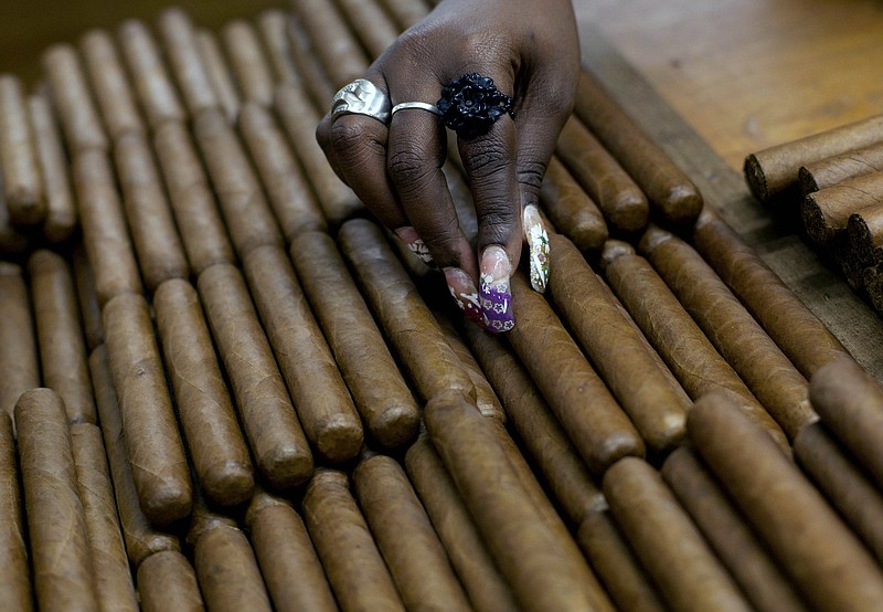 
              FILE - This March 1, 2013 file photo shows a worker selecting cigars at the H. Upmann cigar factory, where people can take tours as part of the 15th annual Cigar Festival in Havana, Cuba. The Obama administration announced Friday, Oct. 14, 2016 it is eliminating a $100 limit on the value of Cuban rum and cigars that American travelers can bring back from the island. (AP Photo/Ramon Espinosa, File)
            