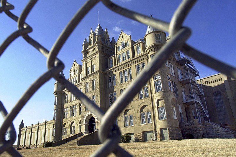 FILE - In this January 2001 file photo, the old Tennessee State Penitentiary is seen through a fence in Nashville, Tenn. The state Department of Correction on Oct. 12, 2016, posted a video featuring drone footage of the crumbling facility that was shuttered in 1992 and was once a favorite film location. (AP Photo/Mark Humphrey, file)