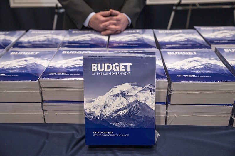 In this Feb. 9, 2016, file photo, copies of President Barack Obama's fiscal 2017 federal budget are displayed by the Senate Budget Committee, on Capitol Hill in Washington. The government ran a $587 billion budget deficit for the just-completed fiscal year, a 34 percent spike over last year after significant improvement from the record deficits of President Barack Obama's first years in office.