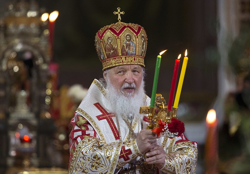 
              FILE - In this file photo dated Sunday, May 1, 2016, Russian Orthodox Patriarch Kirill holds candles during the Easter service in the Christ the Savior Cathedral in Moscow, Russia. The head of Russia's Orthodox Church, Patriarch Kirill begins a four-day visit to Britain, on upcoming  Saturday Oct. 15, 2016, that includes an audience with Britain's Queen Elizabeth II. (AP Photo/Alexander Zemlianichenko, FILE )
            