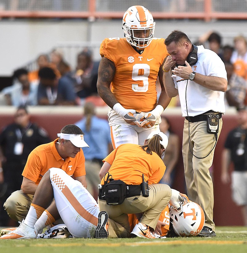 Tennessee head coach Butch Jones and Derek Barnett (9) check on a injured Kendal Vickers (39).  The top-ranked University of Alabama Crimson Tide visited the University of Tennessee Volunteers in SEC football action on October 15, 2016