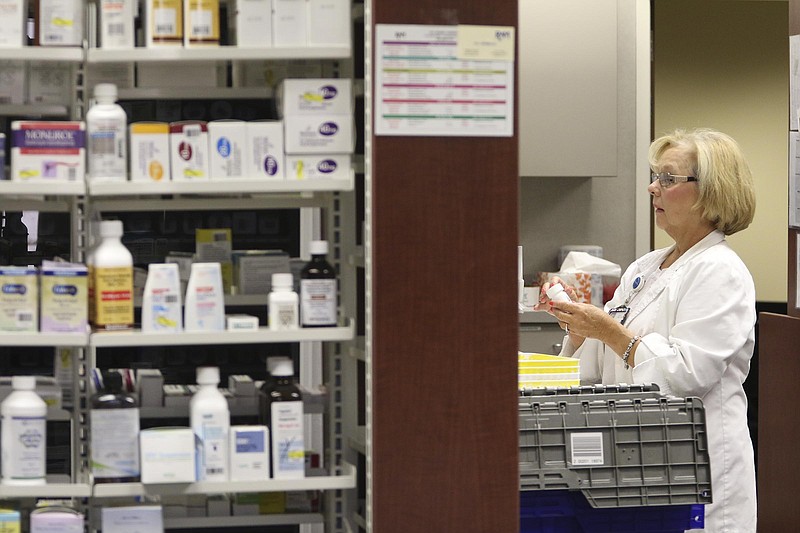 Staff Photo by Dan Henry / The Chattanooga Times Free Press- 10/12/16. Susan McBryar, a certified pharmacy technician with the Erlanger Pharmacy, fills patients prescriptions while in the Erlanger Hospital Pharmacy on October, 12, 2016. 