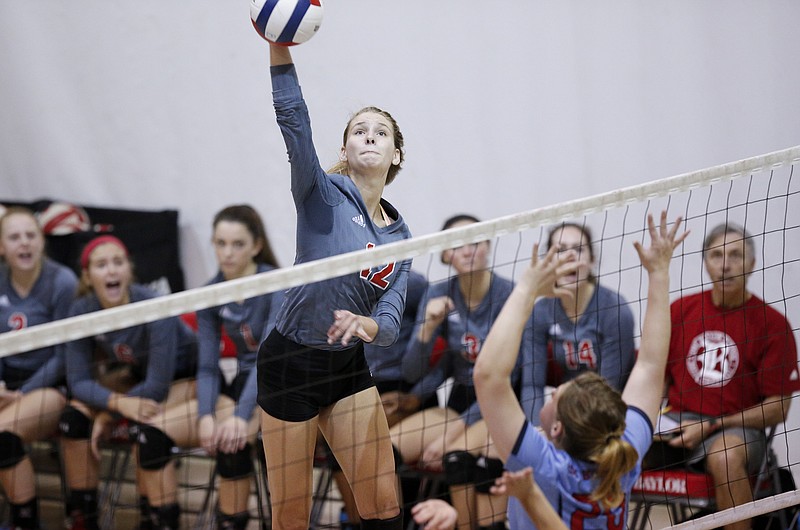 Baylor's Ally Craig spikes the ball towards St. Benedict's Kat Vinton during the Red Raiders' volleyball match against St. Benedict at Baylor School on Saturday, Oct. 15, 2016, in Chattanooga, Tenn.