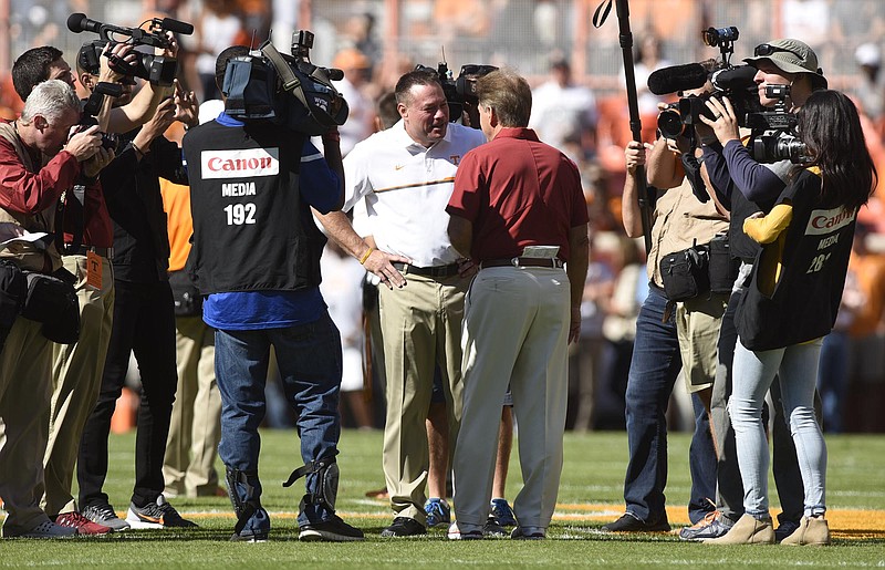 Staff Photo by Robin Rudd Head coaches Butch Jones and Nick Saban are surrounded by photographers before the game. The top-ranked University of Alabama Crimson Tide visited the University of Tennessee Volunteers in SEC football action on October 15, 2016