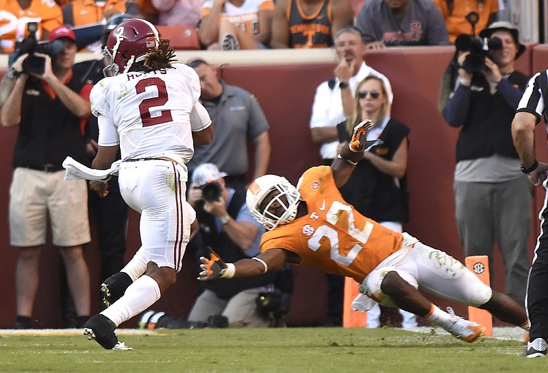 Alabama quarterback Jalen Hurts (2) dodges the attempted tackle of Tennessee's Micah Abernathy (22).  The top-ranked University of Alabama Crimson Tide visited the University of Tennessee Volunteers in SEC football action on October 15, 2016