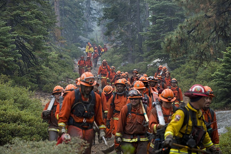 
              CORRECTS LOCATION OF FIRE SOUTH LAKE TAHOE, CALIFORNIA - Hand crews finish up work on the Emerald Fire along Highway 89, Friday, Oct. 14, 2016 on the southwest shores of Lake Tahoe. The blaze that burned about 200 acres northwest of South Lake Tahoe, California was one of three wind-whipped wildfires burning along the Sierra Nevada. The largest one destroyed more than 20 homes in a rural valley between Carson City and Reno, Nevada. (Randall Benton/The Sacramento Bee via AP)
            