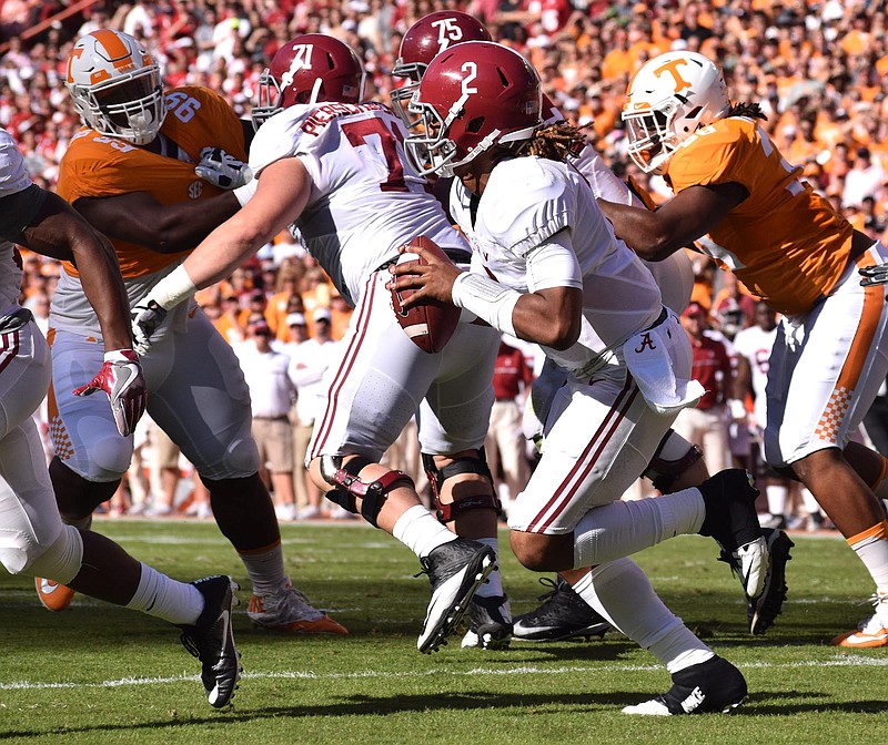 Alabama's offensive line protects quarterback Jalen Hurts as he looks for an open receiver during Saturday's 49-10 win against Tennessee in Knoxville.