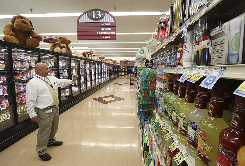 Staff Photo by Dan Henry / The Chattanooga Times Free Press- 10/13/16. David Smith, store manager of Food City 738 in Soddy-Daisy, speaks about the area he has designated to display wine if sales are approved while walking through his grocery store on October, 13, 2016. 