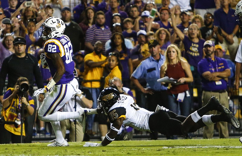 LSU wide receiver D.J. Chark (82) gets past Southern Mississippi defensive back Devonta Foster (15) for a touchdown during the first half of an NCAA college football game, Saturday, Oct. 15, 2016, in Baton Rouge, La. (AP Photo/Butch Dill)


