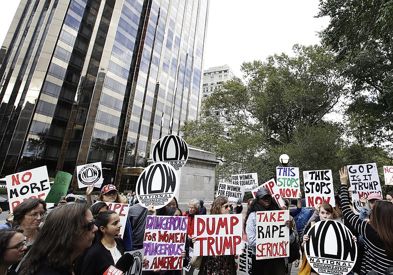 Protesters organized by the National Organization for Women gather near the Trump International Hotel and Tower on last week in New York. Hillary Clinton is pressing Republicans to take a clear stand on Donald Trump as she tries to capitalize on GOP divisions since revelation of his predatory comments about women prompted party leaders to abandon him. (AP Photo/Frank Franklin II)