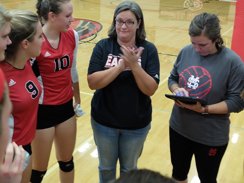 Signal Mountain volleyball coach Jennifer Redman gives her girls a hand after winning the District 7-AA championship match over Notre Dame Oct. 7. With the Eagles' win over Hixson last week, the team is headed to the state championships.