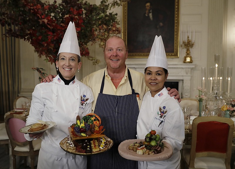 
              From left, White House Executive Pastry Chef Susan Morrison, American chef Mario Batali, and White House Executive Chef Cris Comerford pose for photographers during a preview in advance of the State Dinner in honor of the Official Visit of Italian Prime Minister Matteo Renzi and his wife Agnese Landini, Monday, Oct. 17, 2016, in the State Dining Room of the White House in Washington. (AP Photo/Carolyn Kaster)
            