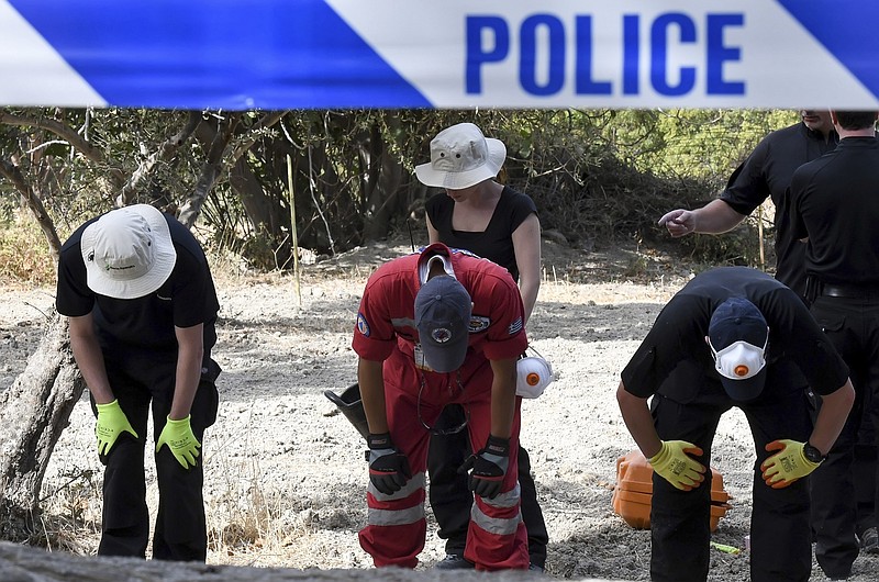 
              FILE - In this Monday, Sept. 26, 2016 file photo, British officers and members of the Greek rescue team search an area of land on the southeastern Greek island of Kos. A British toddler who went missing on a Greek island 25 years ago is believed to have been killed in a construction-site accident that was covered up for almost a quarter of a century, police said Monday, Oct. 17, 2016. (Nikos Panagiotopoulos/InTime News via AP, file)
            