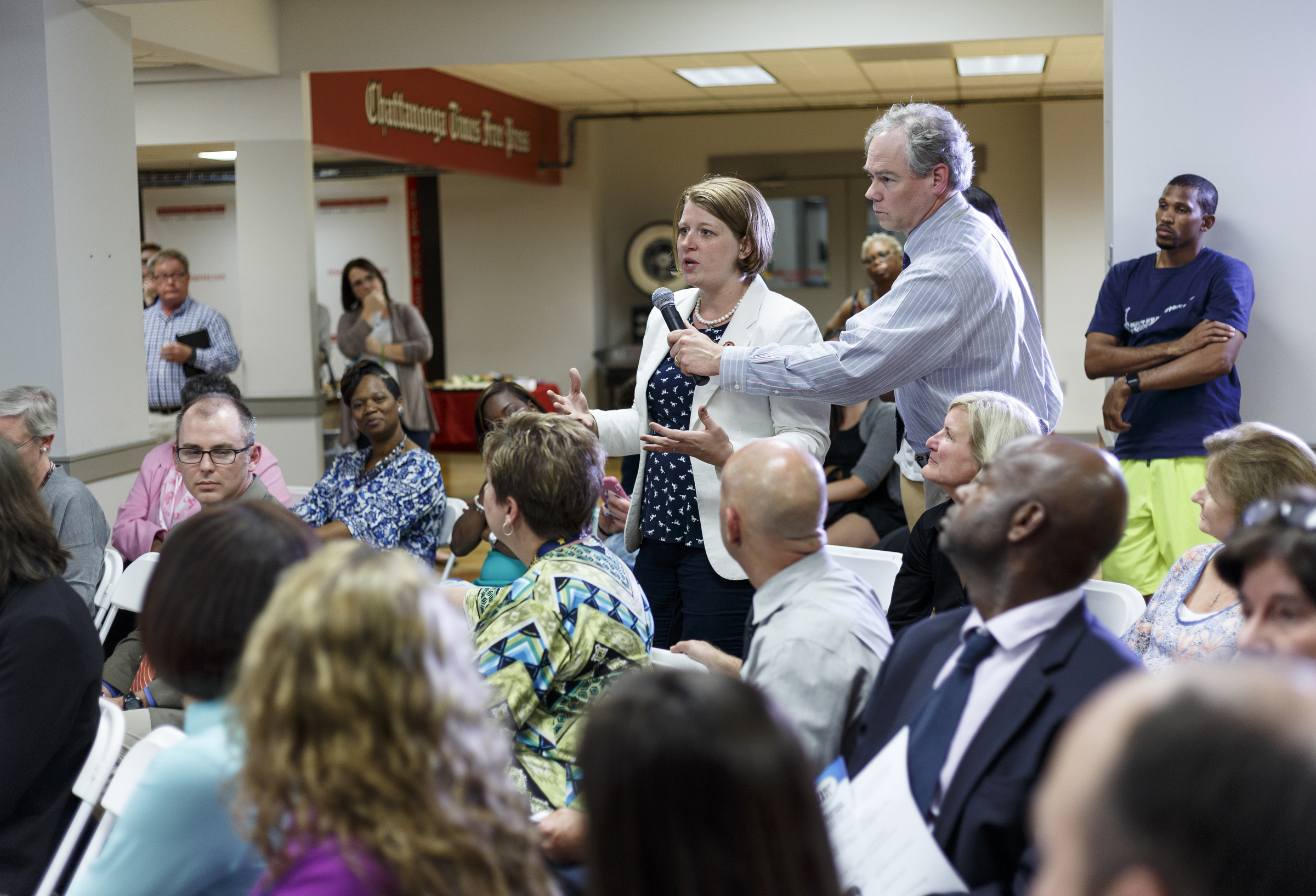 Metro editor Alex Chambliss holds the microphone as Khristy Wilkinson asks a question during a forum hosted by the Times Free Press titled