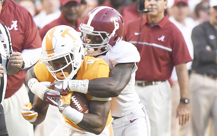 Tennessee's John Kelly (4) is pulled down by Alabama's Hootie Jones (6).  The top-ranked University of Alabama Crimson Tide visited the University of Tennessee Volunteers in SEC football action on October 15, 2016