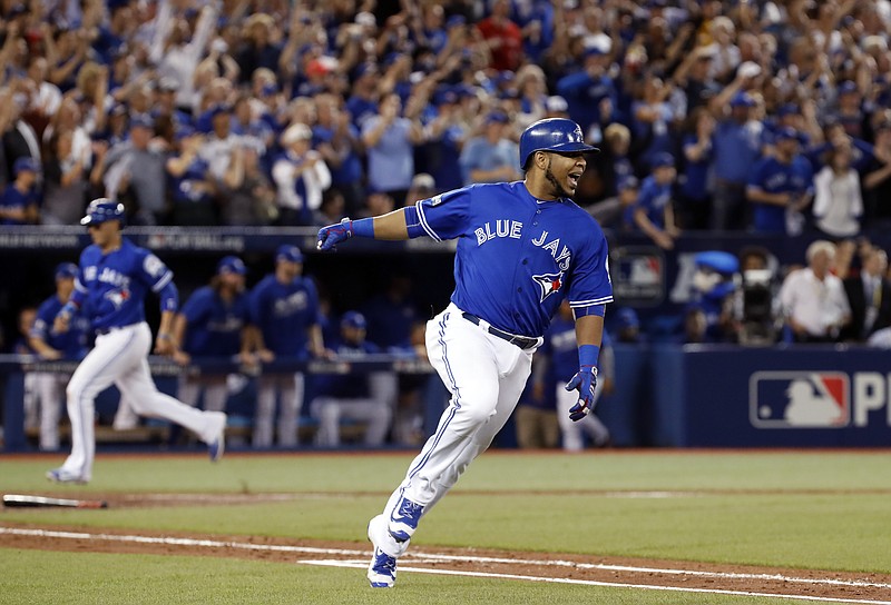 
              Toronto Blue Jays' Edwin Encarnacion celebrates after his two-RBI double against the Cleveland Indians during the seventh inning in Game 4 of baseball's American League Championship Series in Toronto, Tuesday Oct. 18, 2016. (Mark Blinch/The Canadian Press via AP)
            