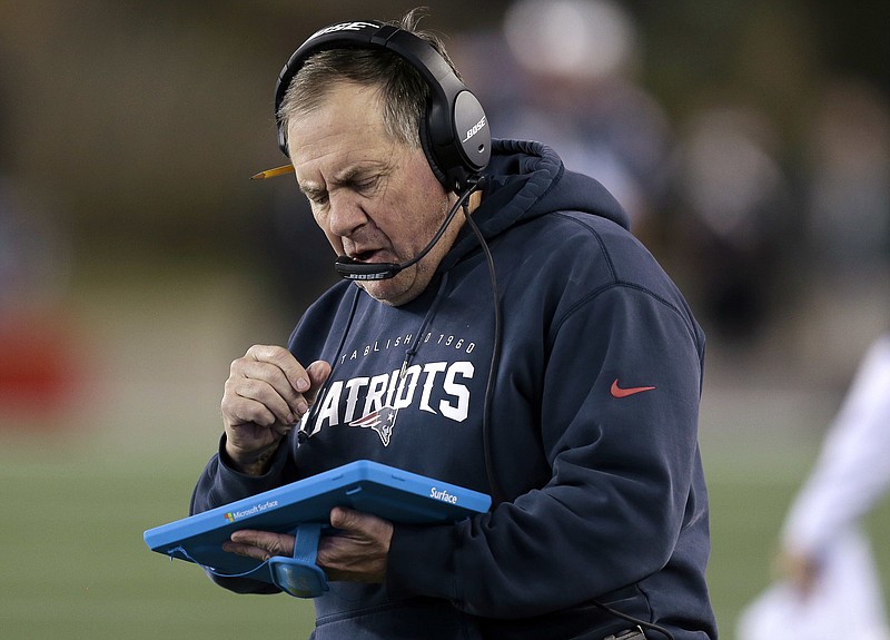 
              FILE - In this Dec. 6, 2015, file photo, New England Patriots head coach Bill Belichick studies a tablet device along the sideline during the first half of an NFL football game against the Philadelphia Eagles in Foxborough, Mass. Belichick said Tuesday, Oct. 18, 2016, that he's through using the sideline tablets, saying there isn't enough consistency in the performance of the devices. (AP Photo/Charles Krupa, File)
            