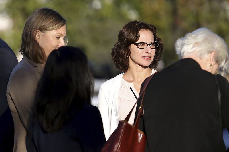 
              Sabrina Erdely, center, enters the federal courthouse in Charlottesville, Va., on Monday, Oct. 17, 2016. Erdely, author of "A Rape on Campus," a discredited Rolling Stone article detailing an alleged rape at the University of Virginia, is being sued by Nicole Eramo, a UVa administrator included in the story. (Ryan M. Kelly/The Daily Progress via AP)
            