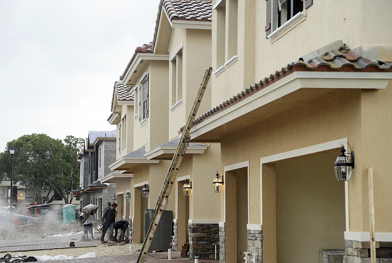 
              FILE - In this Thursday, Sept. 22, 2016, file photo, Lennar Corporation townhomes are under construction at Chelsea Place in Tamarac, Fla. On Wednesday, Oct. 19, 2016, the Commerce Department reports on U.S. home construction in September. (AP Photo/Lynne Sladky, File)
            