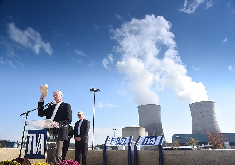 Tennessee Valley Authority Chief Nuclear Officer Joe Grimes tips his hat Wednesday morning as  Bill Johnson, second from right, president and CEO of TVA, announces full that Watts Bar Nuclear Plant has reached full power.
