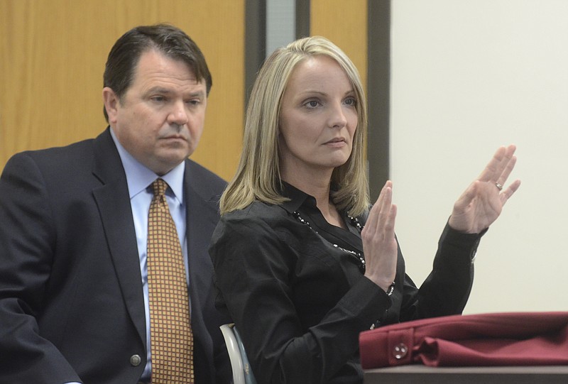 Tammy Davis, right, speaks as attorney McCracken Poston listens during a 2012 meeting.