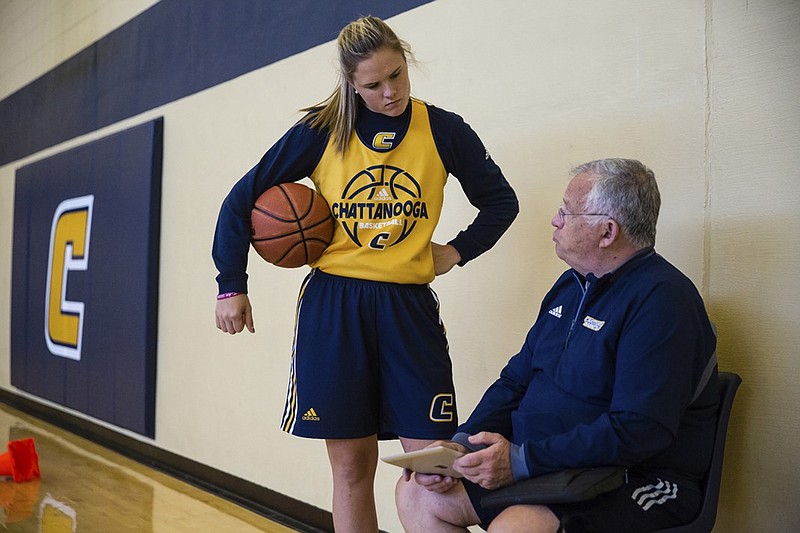 UTC women's basketball player Shelbie Davenport talks with coach Jim Foster during a Mocs practice earlier this month. Davenport sat out last season after transferring from Clemson.