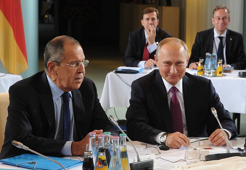 
              Russian President Vladimir Putin, right, and Russian Foreign Minister Sergey Lavrov, left, attend the talks at a summit with the leaders of Russia, Ukraine and France at the chancellery in Berlin, Germany, Wednesday, Oct. 19, 2016.(Mikhail Klimentyev/Pool Photo via AP)
            