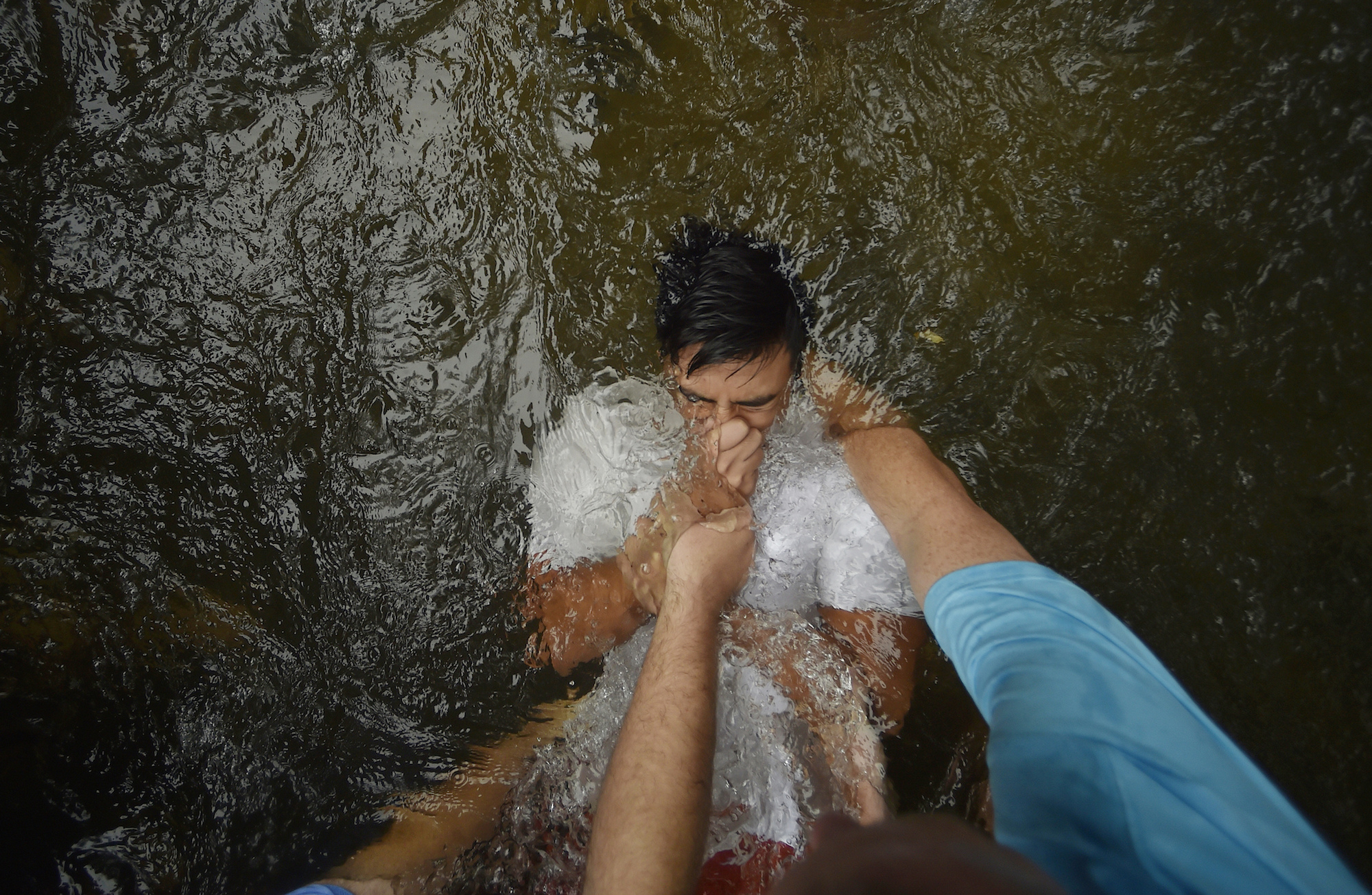 Habersham Central High School student and football player Ronald Butseecha is baptized in the Chattahoochee River, Sunday, Sept. 18, 2016, near Demorest, Ga. (AP Photo/Mike Stewart)