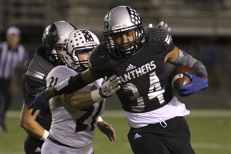 Staff Photo by Dan Henry / The Chattanooga Times Free Press- 10/14/16. Ridgeland High School's Grayson Moore (34) dodges a tackle by Heritage High School's Austin Ferguson (21) during the first half of play at the Panthers' home field on Friday, October 14, 2016. 