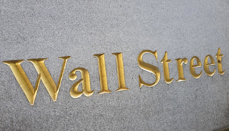 
              A sign for Wall Street is carved into a building located near the New York Stock Exchange, Friday, Oct. 7, 2016. Solid, if uninspiring,  U.S. stocks veered lower in early trading Friday, Oct. 21,  as investors pored through earnings from General Electric, McDonald’s and other big companies. (AP Photo/Mark Lennihan)
            