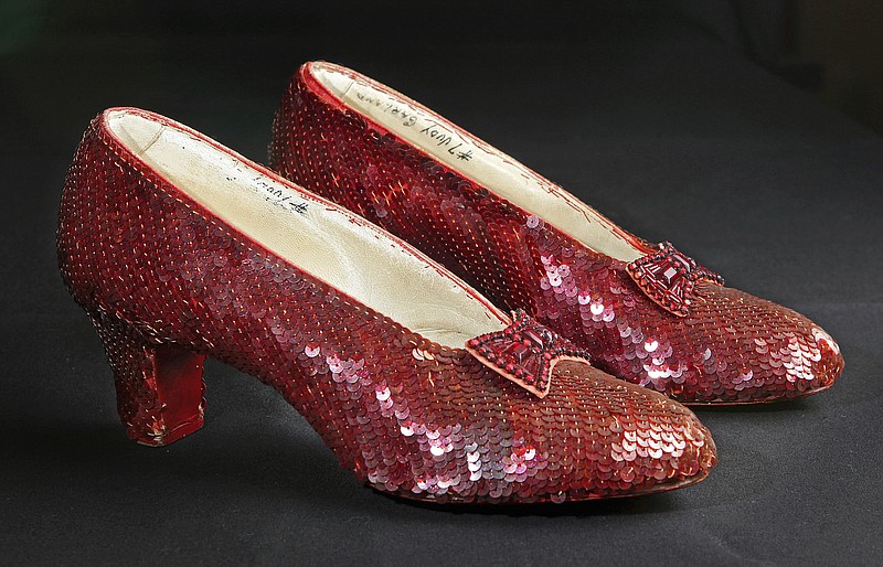 
              File- This Nov. 9, 2001, file photo shows the sequin-covered ruby slippers worn by Judy Garland in "The Wizard of Oz"  at the offices of Profiles in History in Calabasas, Calif. Smithsonian Museum officials started a Kickstarter fundraising drive Monday, Oct. 17, 2016,  to repair the iconic slippers from 1939’s “The Wizard of Oz” and create a new state-of-the-art display case for them at the National Museum of American History.  (AP Photo/Reed Saxon, File)
            